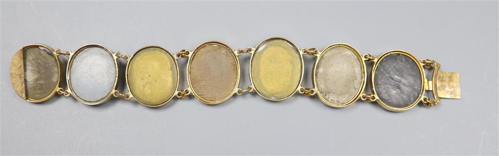 A Victorian gilt metal and lava bracelet, set with seven oval panels carved with busts of ladies and gentleman, 17.2cm.